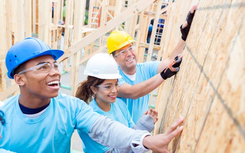 volunteers helping to build a home